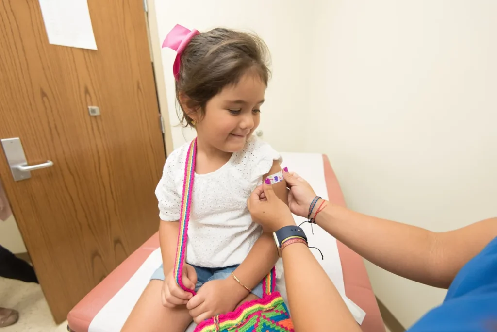Pediatric nurse preparing a childhood immunization
