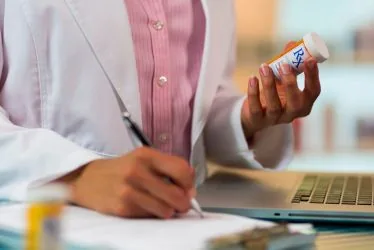 Physician reviewing a prescription refill request