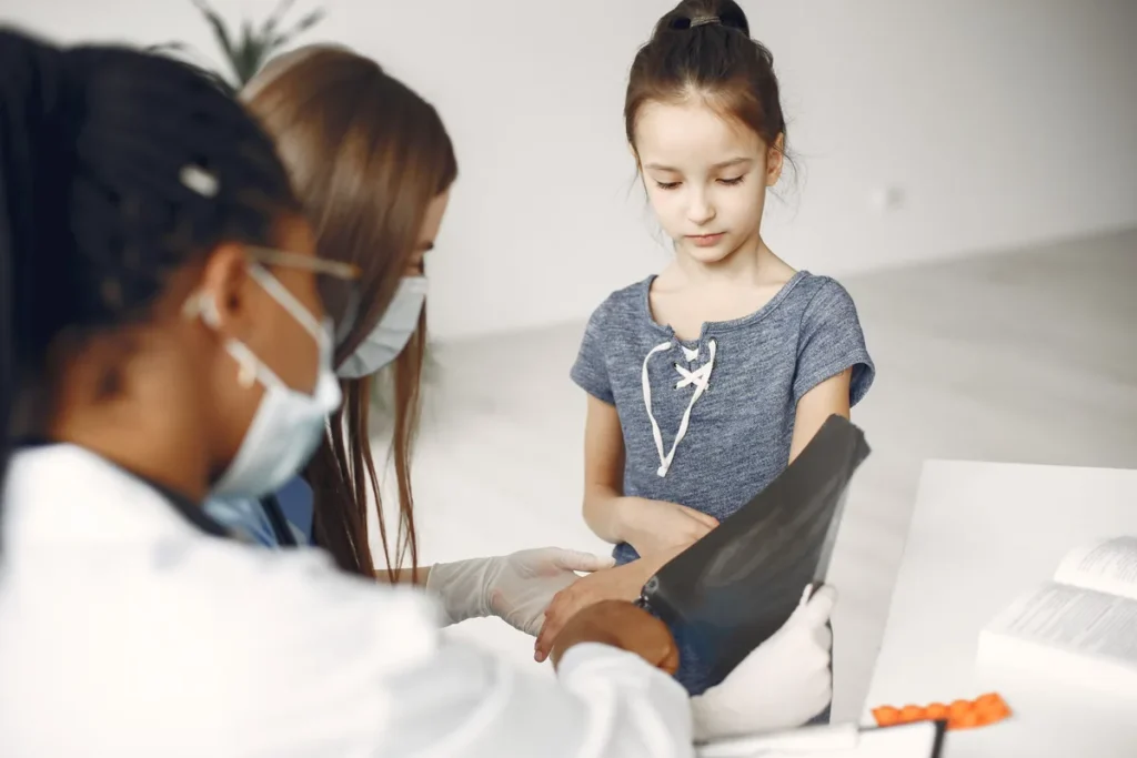 Doctor examining a sick child during a same-day appointment